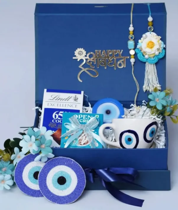 Rakhi Chocolate Gift Hampers including Couple Rakhi, Evil Eye Cup, Chocolates, Evil Eye Sigil, and Mouth Freshener