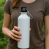A vibrant green Dino Theme Kids Sipper Bottle featuring playful dinosaur illustrations and a convenient spill-proof straw lid.