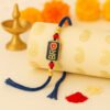 A trendy "Bro Rakhi" featuring a minimalist design, perhaps a metallic charm saying "BRO" or a cool geometric pattern, displayed casually on a wrist, representing a modern sibling bond.