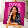 A personalized Mini Canvas with Wooden Easel displaying a smiling woman's portrait with the name "PIYA" in large letters on a vibrant pink background, set on a light wooden easel.