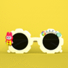 A pair of white, flower-shaped "Personalized Kids Sunglasses with Name" featuring a red bunny character on one side and the personalized name