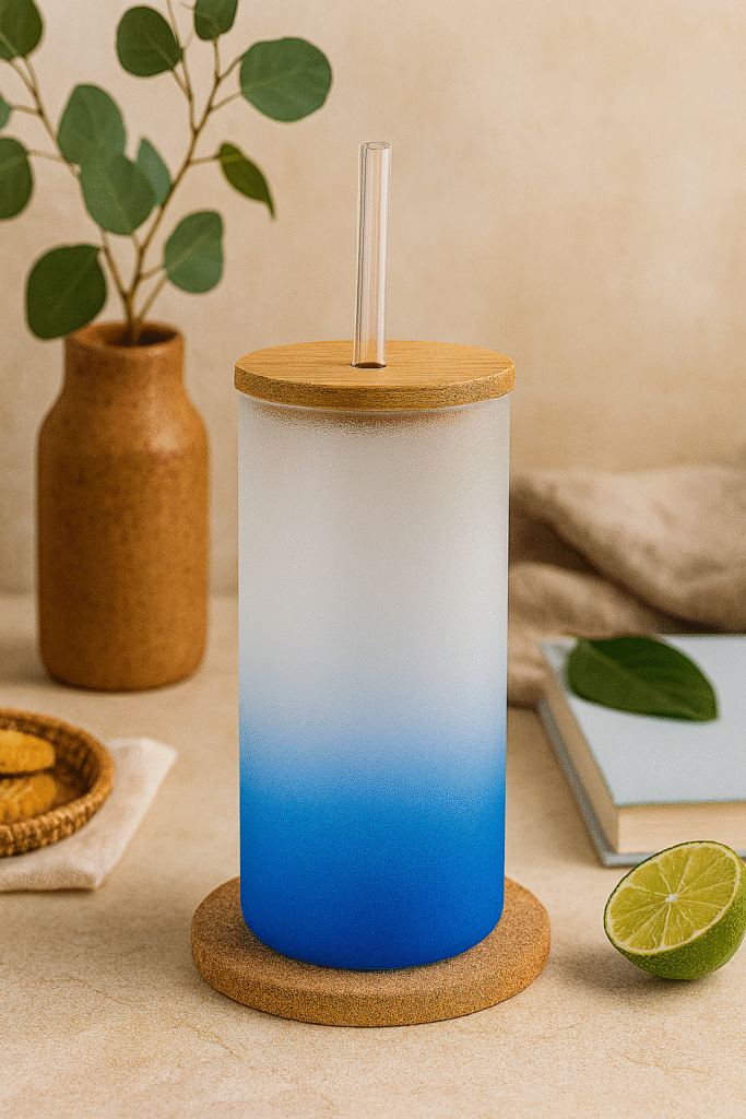 Blue Colored Skinny Tumbler on a coaster with a bamboo lid and glass straw.