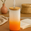 A white and orange gradient Personalized Dinosaur Tumbler for Kids with a bamboo lid and clear straw, featuring colorful illustrations of various dinosaurs, leaves, anchors, and the text "DINO ADVENTURE" and a vertical custom name "Rohan."
