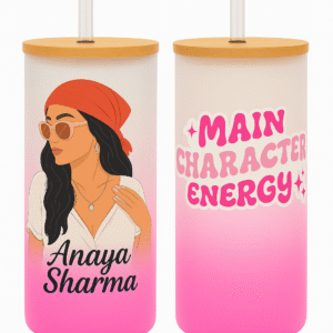 A white and pink gradient Personalized Tumbler for Girls with a bamboo lid and clear straw. One side features an illustration of a stylish girl with a red bandana and sunglasses, and the name "Anaya Sharma." The other side has "MAIN CHARACTER ENERGY" text with star accents.