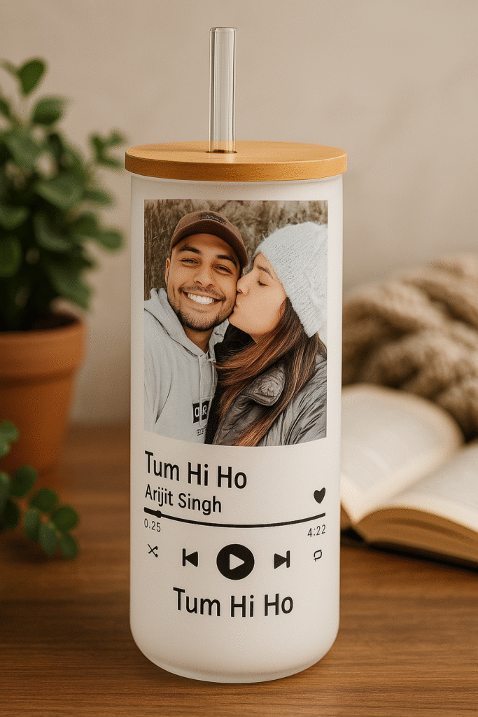 : A white Spotify Code Tumbler with a bamboo lid and clear straw, featuring a custom photo of a couple, song title "Tum Hi Ho," artist "Arijit Singh," Spotify player controls, and the song title repeated at the bottom, mimicking the Spotify interface.