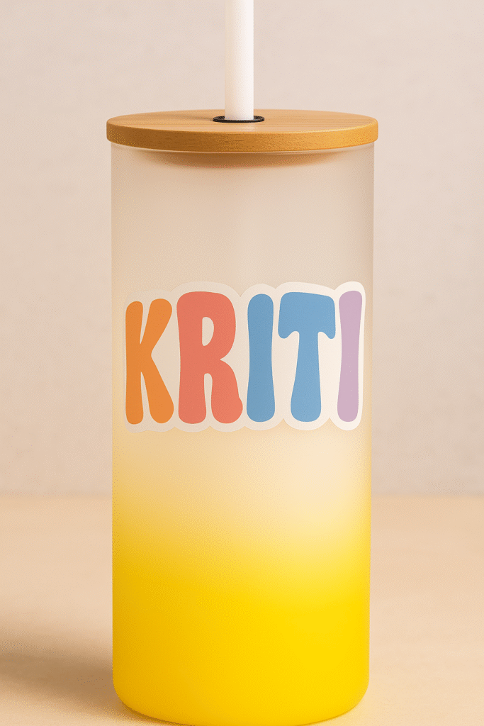 A white and yellow gradient Custom Name Tumbler with Motivational Quote, featuring the name "KRITI" on one side and the word "SLAY" on the other, both in colorful bubbly letters, with a bamboo lid and clear straw.