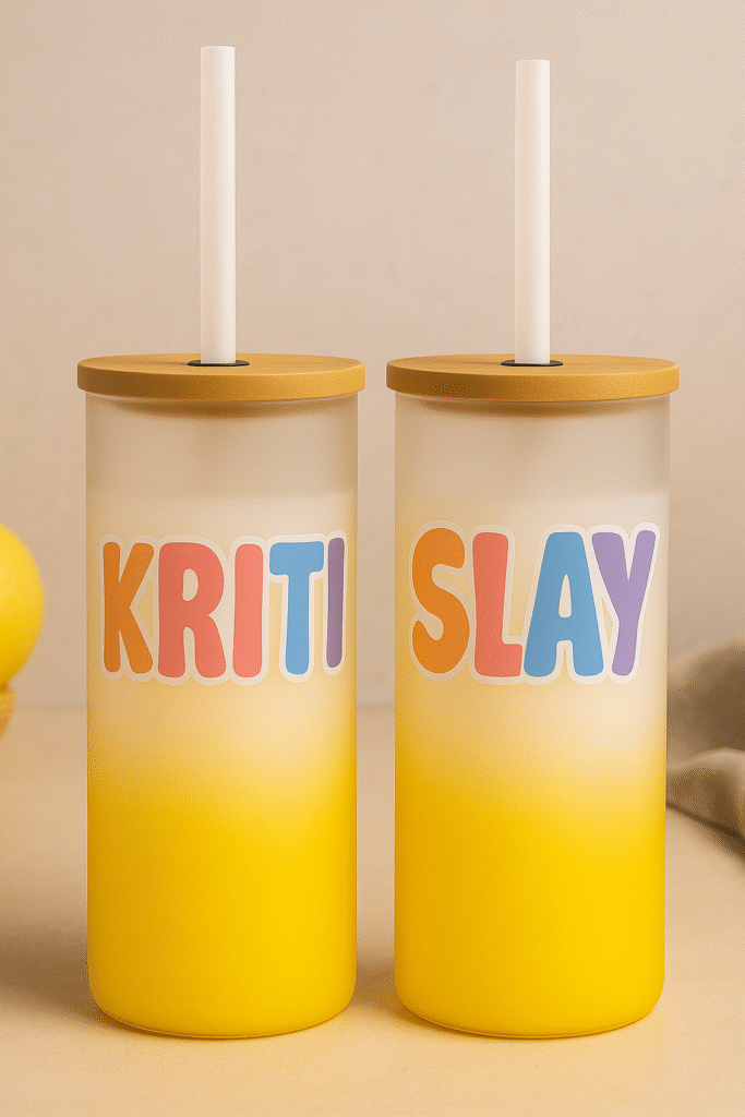 A white and yellow gradient Custom Name Tumbler with Motivational Quote, featuring the name "KRITI" on one side and the word "SLAY" on the other, both in colorful bubbly letters, with a bamboo lid and clear straw.