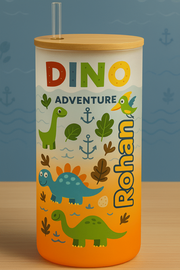 A white and orange gradient Personalized Dinosaur Tumbler for Kids with a bamboo lid and clear straw, featuring colorful illustrations of various dinosaurs, leaves, anchors, and the text "DINO ADVENTURE" and a vertical custom name "Rohan."