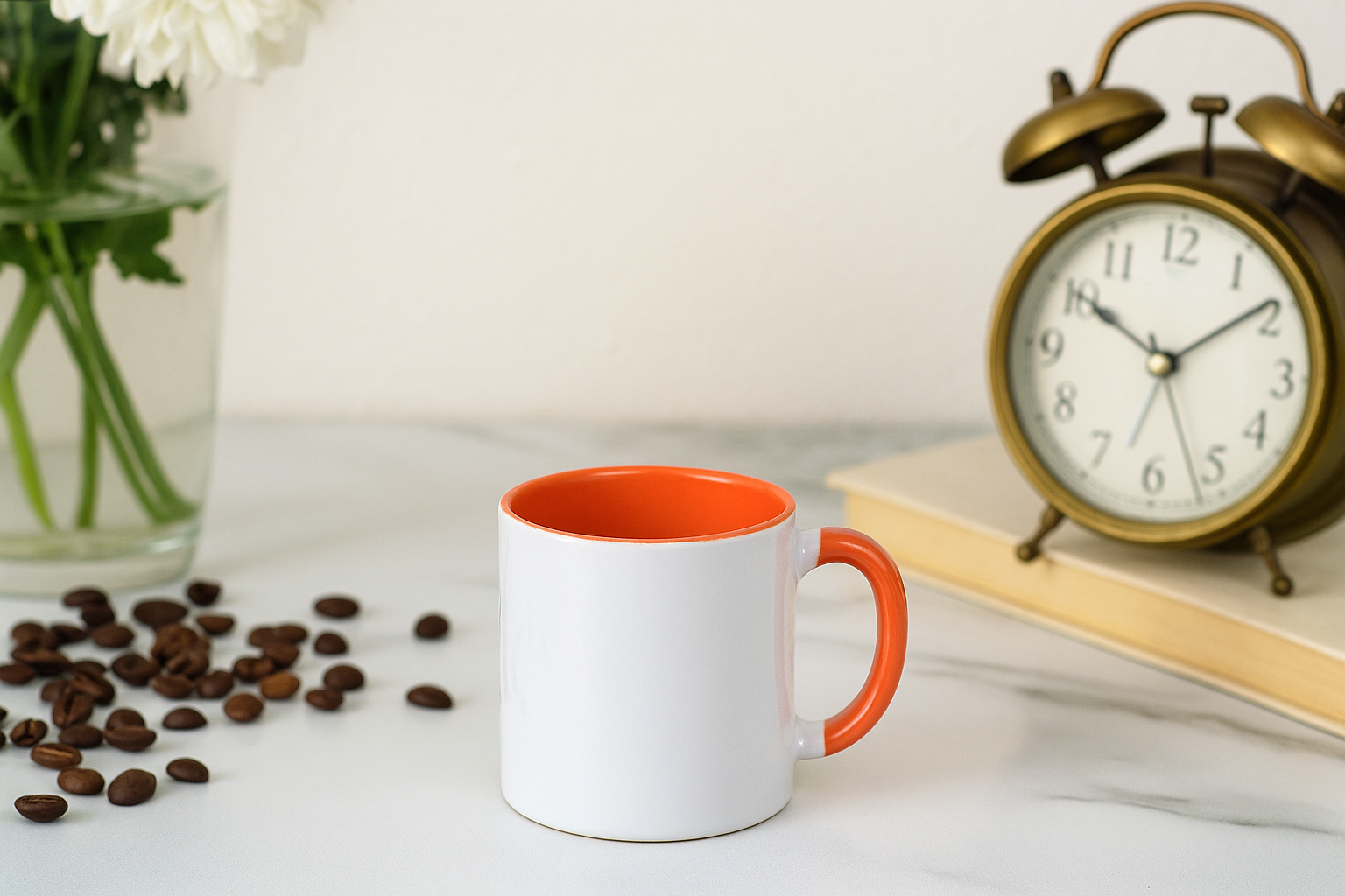 Orange and White Ceramic Coffee Mug a bright orange interior and handle, sitting on a table with an antique clock.