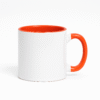 Orange and White Ceramic Coffee Mug a bright orange interior and handle, sitting on a table with an antique clock.