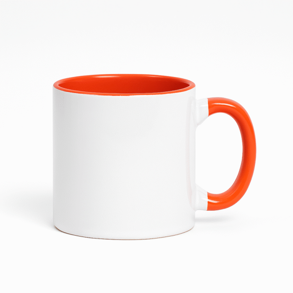 Orange and White Ceramic Coffee Mug a bright orange interior and handle, sitting on a table with an antique clock.