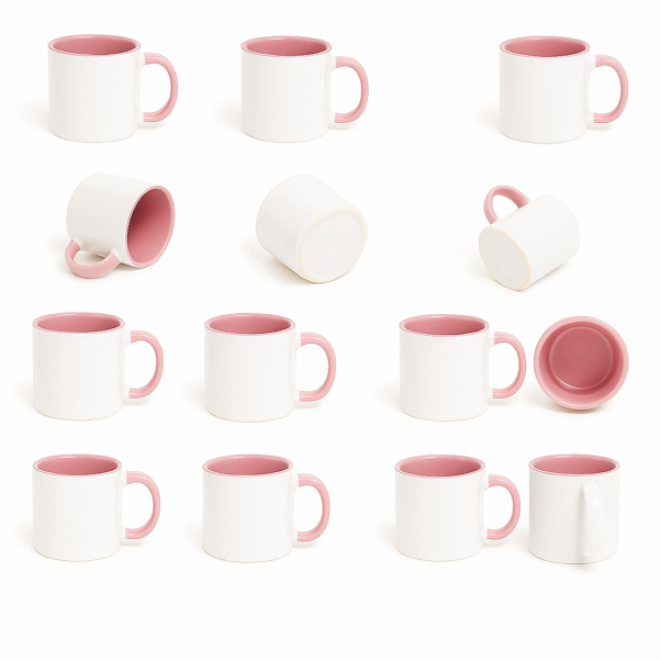 Custom Pink and white ceramic coffee mug with a pink interior and handle, sitting on a wooden table next to a vase with pink flowers, a stack of books, and scattered coffee beans.