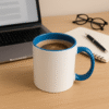 Personalized Blue and White Coffee Mug with Name with a white exterior and a blue interior and handle, sitting on a wooden desk.
