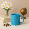 Personalized Blue Coffee Mug with Name "Your Logo Here" printed on the side, sitting on an office desk next to a laptop.