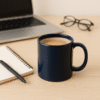 Personalized Navy Blue Coffee Mug with Name or Logo with a glossy finish on a wooden table, next to an open book and a black horse figurine.