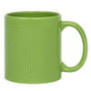 Custom Green ceramic coffee mug sitting on a wooden table, next to a vase with white flowers, a stack of books, and scattered coffee beans.